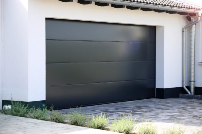 Modern black flush panel garage door